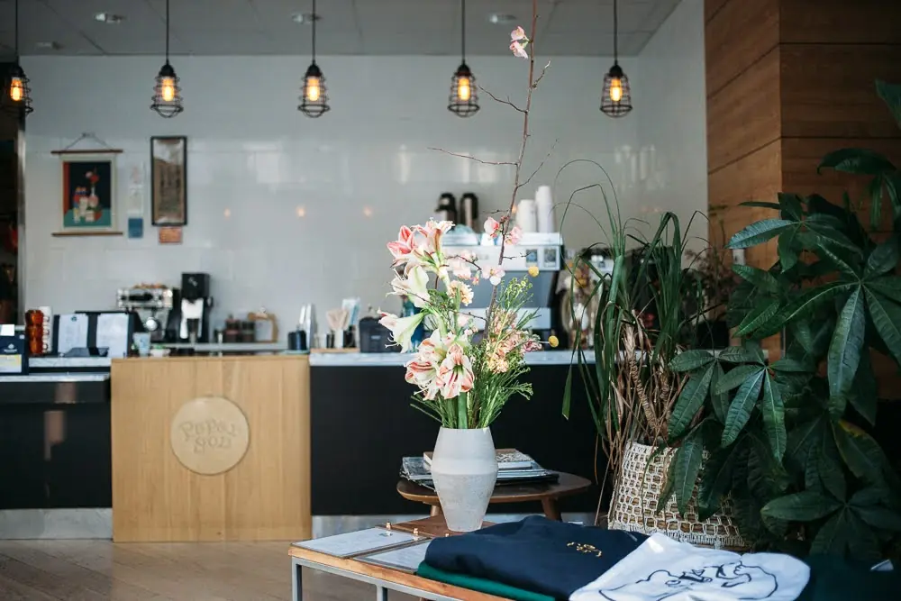 Paper Son Coffee Downtown cafe interior with the bar and fresh flowers